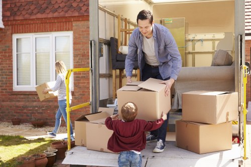 Moving crew beginning a house removal service with boxes and protective equipment