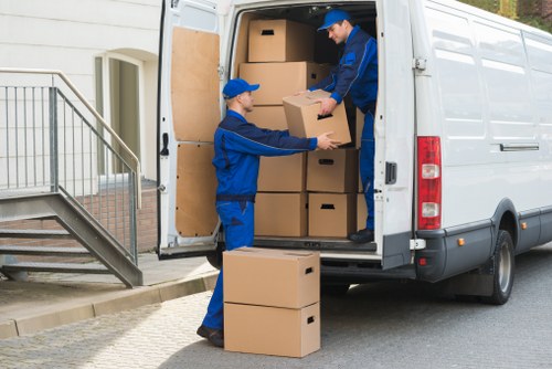 Removal team carrying furniture through a Fulham property
