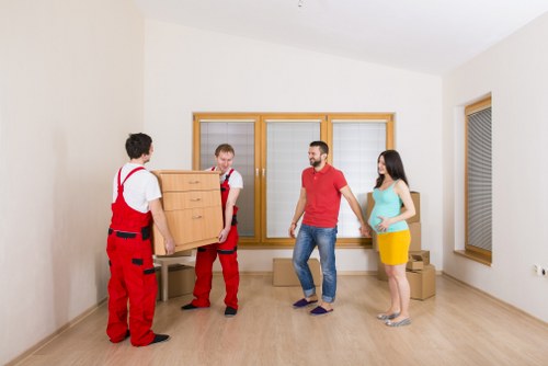 Moving team following safe loading procedures at a vehicle