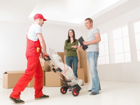 Removal team loading household items into a moving vehicle